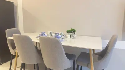 a dining room table with chairs and a white table at KLCC view couple suite 292A at Majestic residence in Kuala Lumpur