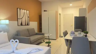 a living room with a couch and a dining room at KLCC view couple suite 292A at Majestic residence in Kuala Lumpur