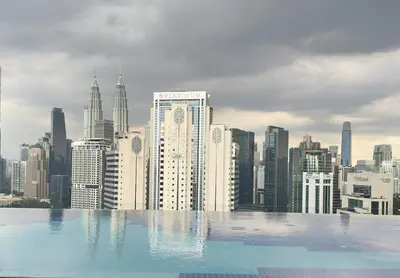 a view of a city skyline from a swimming pool at KLCC view couple suite 292A at Majestic residence in Kuala Lumpur