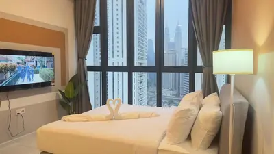 a bedroom with a bed with a large window at KLCC view couple suite 292A at Majestic residence in Kuala Lumpur