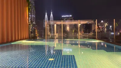 a pool on the roof of a building at night at KLCC view suite 292B at Majestic residence in Kuala Lumpur