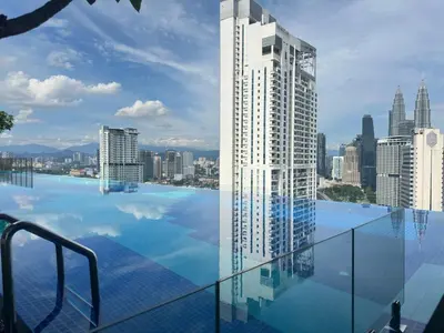 a swimming pool with a view of a city at Couple luxury suite 275B at Majestic Residence in Kuala Lumpur