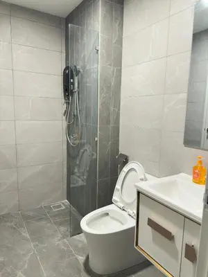 a bathroom with a shower and a toilet and a sink at Private family suite 23171BR at Majestic Residence in Kuala Lumpur