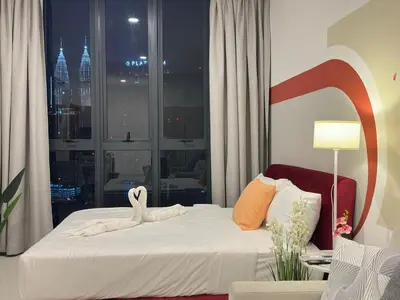a bedroom with a bed with a swan on it at Klcc view Luxe suite 295B at Majestic Residence in Kuala Lumpur