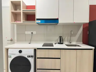 a kitchen with a washing machine and a sink at Klcc view Luxe suite 295B at Majestic Residence in Kuala Lumpur
