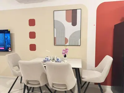 a dining room with a white table and chairs at KLCC view luxury suite 276B at Majestic residence in Kuala Lumpur