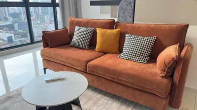 a couch with pillows and a table in a living room at Private family suite 29201BR at Majestic Residence in Kuala Lumpur