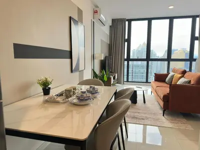 a living room with a dining table and a couch at Private family suite 29201BR at Majestic Residence in Kuala Lumpur