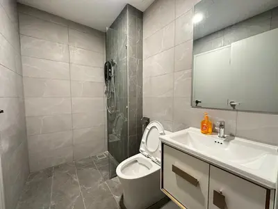 a bathroom with a toilet and a sink and a shower at Private family service suite 2613A1BR at Majestic Residence in Kuala Lumpur