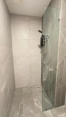 a bathroom with a shower with a glass door at Cozy suite for couple 275A at Majestic Residence in Kuala Lumpur