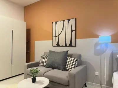 a living room with a couch and a table at Cozy suite for couple 275A at Majestic Residence in Kuala Lumpur
