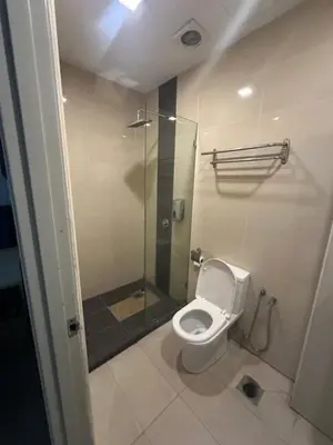 a bathroom with a toilet and a glass shower at SS GREY INN Bb in Kuala Lumpur