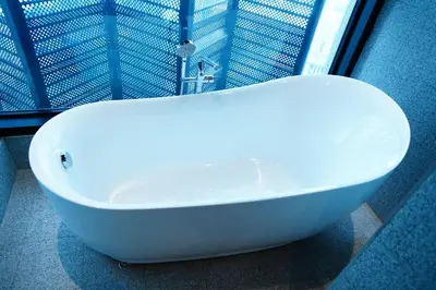 a white bath tub sitting in front of a window at Scarletz Suites By Home Stay in Kuala Lumpur