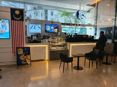 a man standing at the counter of a restaurant at Binjai 8 Comfort Hospitality in Kuala Lumpur