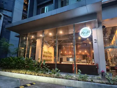 a restaurant with a sign on the side of a building at Binjai 8 Comfort Hospitality in Kuala Lumpur