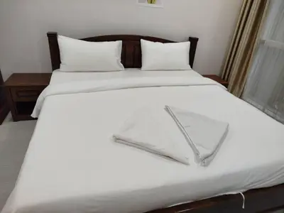 a large white bed with white sheets and pillows at Binjai 8 Comfort Hospitality in Kuala Lumpur