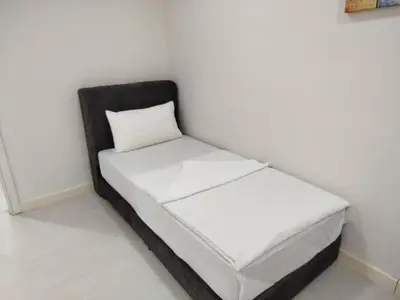 a small bed in a corner of a room at Binjai 8 Comfort Hospitality in Kuala Lumpur
