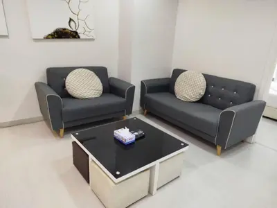 a living room with two couches and a coffee table at Binjai 8 Comfort Hospitality in Kuala Lumpur