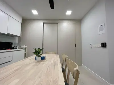 a kitchen and dining room with a wooden table and chairs at Sentral Suites KL Sentral Kuala Lumpur by Nestaway in Kuala Lumpur