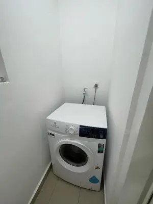 a washing machine in a corner of a room at Sentral Suites KL Sentral Kuala Lumpur by Nestaway in Kuala Lumpur