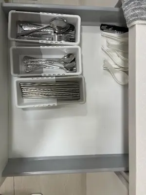 an open refrigerator with silver utensils in it at Sentral Suites KL Sentral Kuala Lumpur by Nestaway in Kuala Lumpur