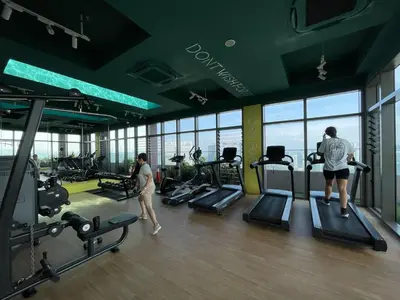two people in a gym with a view of the city at The Riv Riveria City KL Sentral Kuala Lumpur by Nestaway in Kuala Lumpur