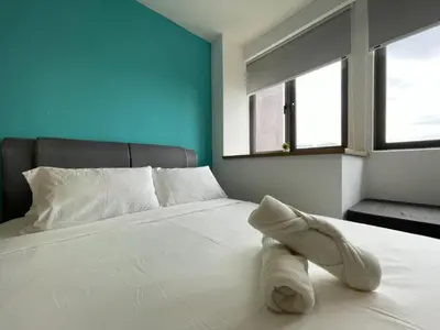 a white bed with a stuffed animal on it at The Riv Riveria City KL Sentral Kuala Lumpur by Nestaway in Kuala Lumpur