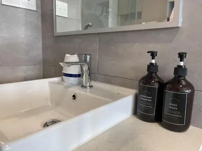 two bottles of soap sitting on a bathroom sink at The Riv Riveria City KL Sentral Kuala Lumpur by Nestaway in Kuala Lumpur