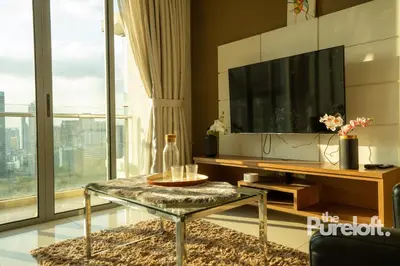 a living room with a tv and a glass table at The Pureloft Suites - Bukit Bintang KLCC in Kuala Lumpur