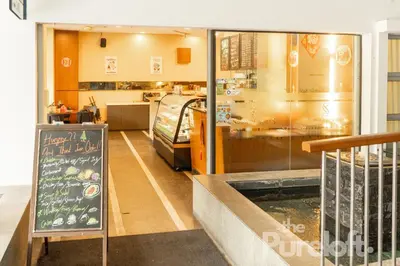 a restaurant with a chalkboard in front of a counter at The Pureloft Suites - Bukit Bintang KLCC in Kuala Lumpur