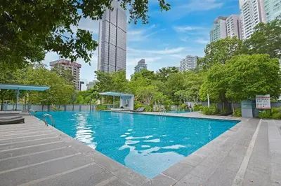 a swimming pool in a city with tall buildings at The Pureloft Suites - Bukit Bintang KLCC in Kuala Lumpur