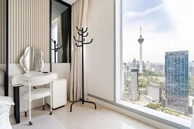 a bedroom with a white desk and a large window at Romantic Home in KLCC in Kuala Lumpur