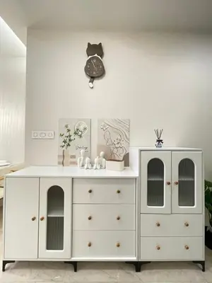 a white dresser with a clock on the wall at Romantic Home in KLCC in Kuala Lumpur