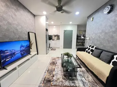 a living room with a couch and a large flat screen tv at Mercu summer suites klcc luxury couple 1BR apartment with balcony, pool view free Netflix in Kuala Lumpur