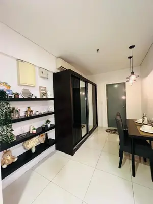 a dining room with a table and a black cabinet at Mercu summer suites klcc luxury couple 1BR apartment with balcony, pool view free Netflix in Kuala Lumpur