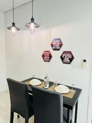 a dining room table with chairs and plates on it at Mercu summer suites klcc luxury couple 1BR apartment with balcony, pool view free Netflix in Kuala Lumpur