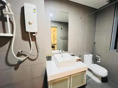a bathroom with a sink and a toilet and a mirror at Mercu summer suites klcc luxury couple 1BR apartment with balcony, pool view free Netflix in Kuala Lumpur