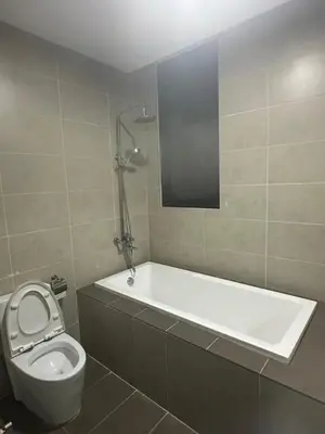 a bathroom with a tub and a toilet and a sink at KL Gateway Premium Service Residence At University malaya in Kuala Lumpur