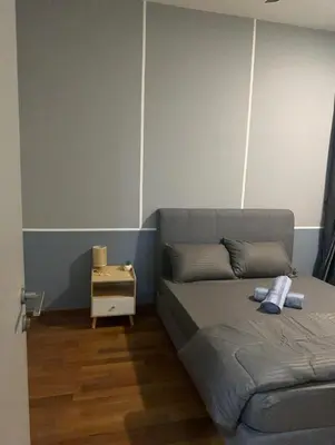 a bedroom with a bed and a night stand at KL Gateway Premium Service Residence At University malaya in Kuala Lumpur