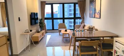 a living room with a table and a dining room at Service Apartment Agile Residence KL in Kuala Lumpur