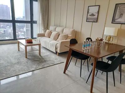 a living room with a couch and a table with chairs at Service Apartment Agile Residence KL in Kuala Lumpur