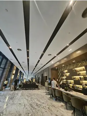 a lobby of a building with people sitting at tables at Star residence KLCC by J&K in Kuala Lumpur