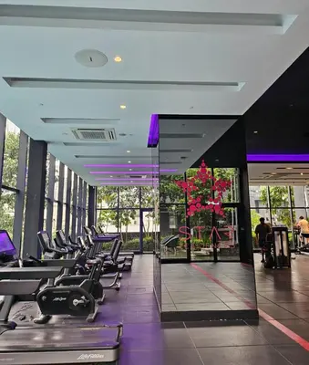 a gym with rows of exercise equipment in a building at Star residence KLCC by J&K in Kuala Lumpur