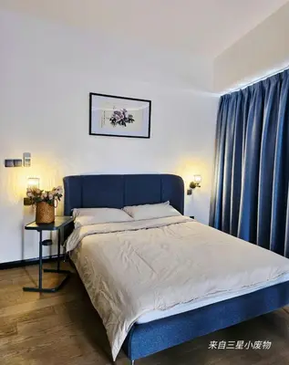 a bed with a blue headboard in a bedroom at Star residence KLCC by J&K in Kuala Lumpur
