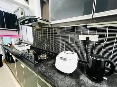 a kitchen with a toaster sitting on a counter at Homestay Ustaz Lumayan in Kuala Lumpur