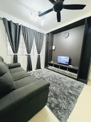 a living room with a couch and a flat screen tv at Homestay Ustaz Lumayan in Kuala Lumpur