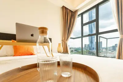 a hotel room with a table with glasses on it at Suasana by TPL - Bukit Bintang KLCC in Kuala Lumpur