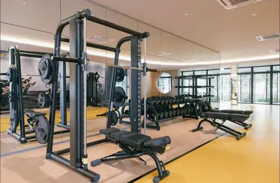 a gym with rows of treadmills and machines at M Vertica w Infinity Pool Mrt TRX Sunway Velocity in Kuala Lumpur
