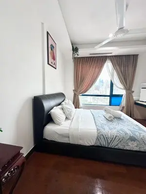 a bedroom with a large bed with a window at Casa Residency in Kuala Lumpur