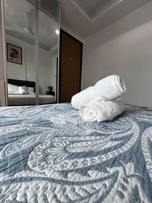 a bedroom with a bed with two towels on it at Casa Residency in Kuala Lumpur